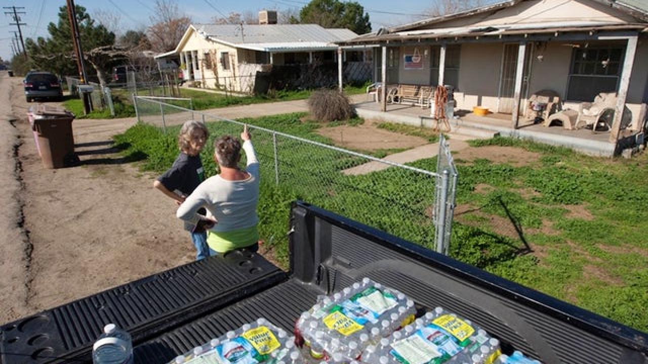 Donna Johnson and Becky Keck talk as Johnson delivers donated drinking water to neighborhood households where wells remain dry in the fourth year of worsening drought on 02/11/15 in East Porterville, CA. David McNew/Getty Images Water Deeply
